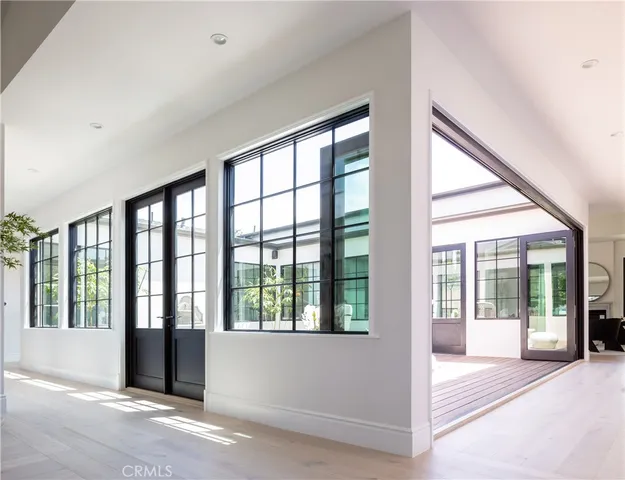a living room with fireplace furniture and a large window