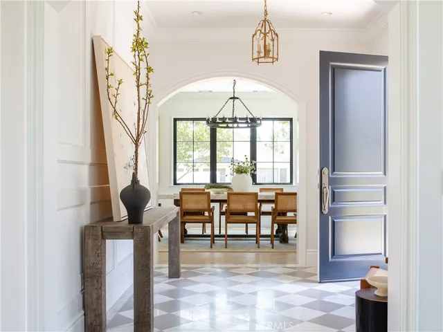 a living room with furniture a table and a chandelier