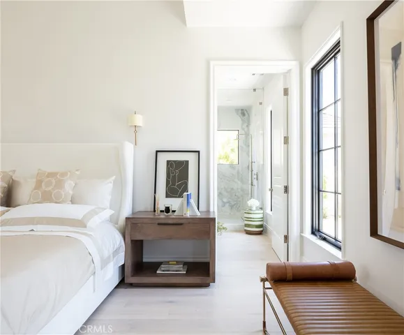 a bedroom with a bed and a chandelier