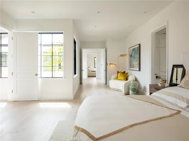 a bathroom with a toilet a sink a mirror a bathtub and vanity