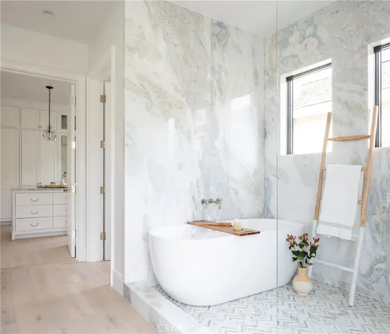 a bedroom with a bed table and a potted plant