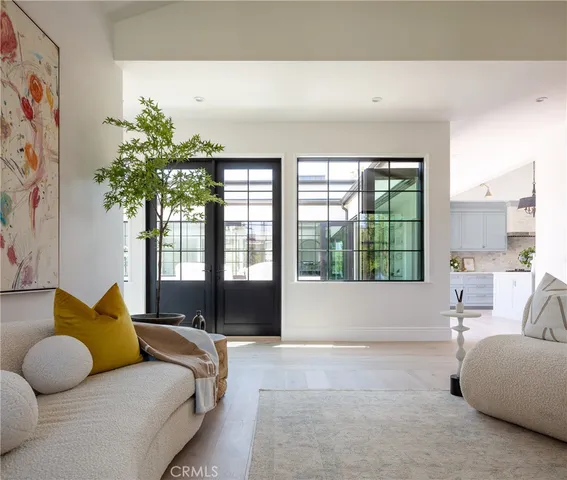 a bedroom with furniture and a large window