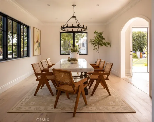 a dining room with furniture window and wooden floor
