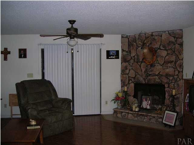 4250 Stephens Road Pace, FL 32571 - Photo 2 of 7 Living Room with beautiful stone fireplace and hardwood floors