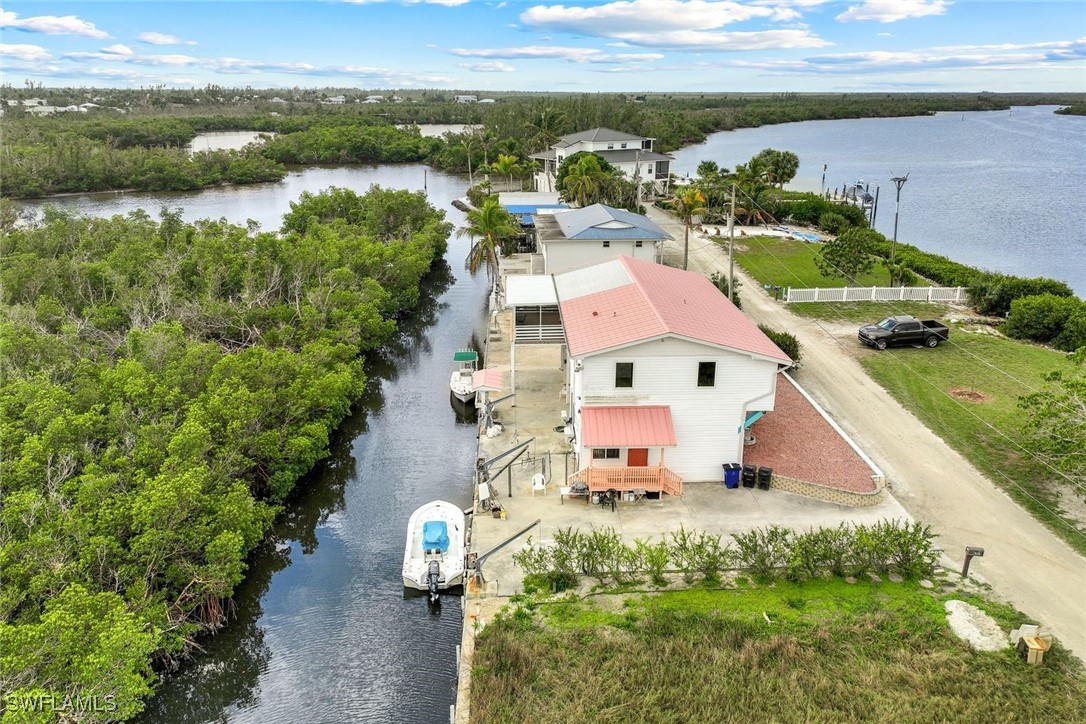 an aerial view of residential houses with outdoor space and river