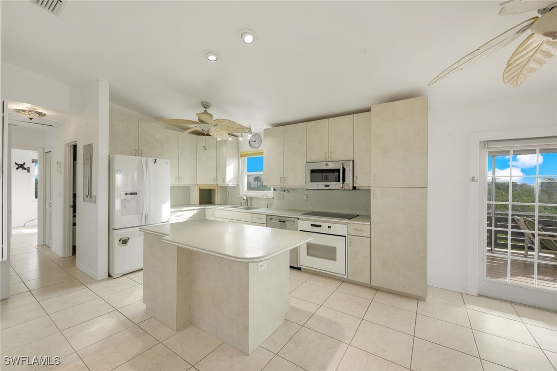 8151 Moyer Lane Bokeelia, FL 33922 - Photo 11 of 49 a kitchen with cabinets and stainless steel appliances