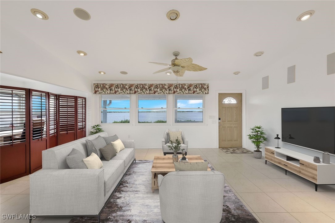 8151 Moyer Lane Bokeelia, FL 33922 - Photo 12 of 49 a living room with furniture and a flat screen tv