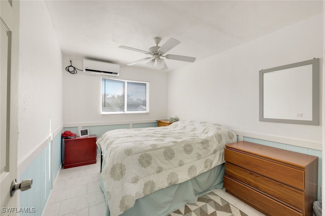 8151 Moyer Lane Bokeelia, FL 33922 - Photo 17 of 49 a bedroom with a bed and window