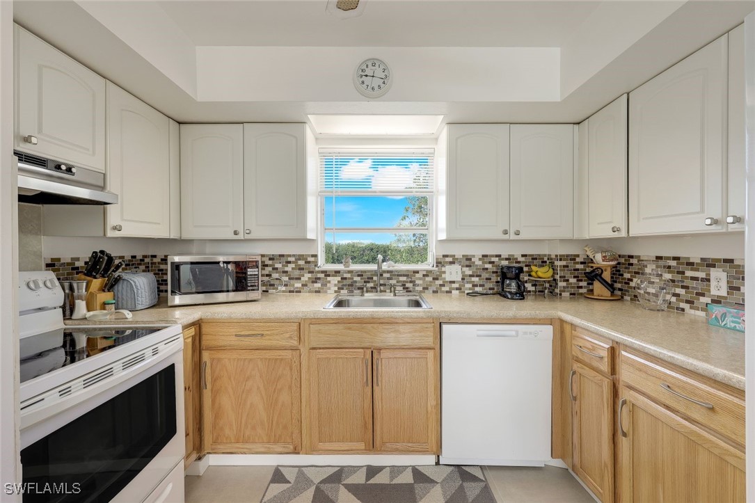 8151 Moyer Lane Bokeelia, FL 33922 - Photo 19 of 49 a kitchen with stainless steel appliances granite countertop a sink stove and cabinets
