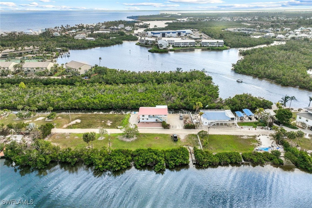 8151 Moyer Lane Bokeelia, FL 33922 - Photo 2 of 49 an aerial view of residential houses with outdoor space and river