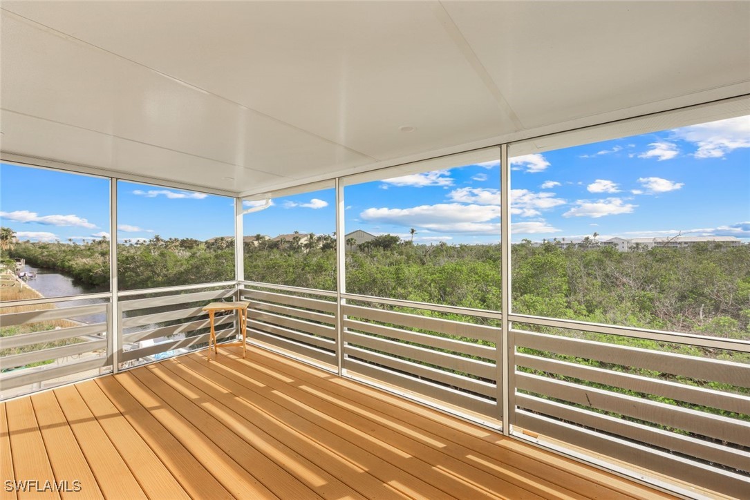8151 Moyer Lane Bokeelia, FL 33922 - Photo 22 of 49 a view of a glass door with a floor to ceiling window next to a road