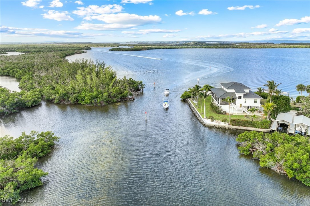 8151 Moyer Lane Bokeelia, FL 33922 - Photo 3 of 49 a view of a lake with a mountain in the background
