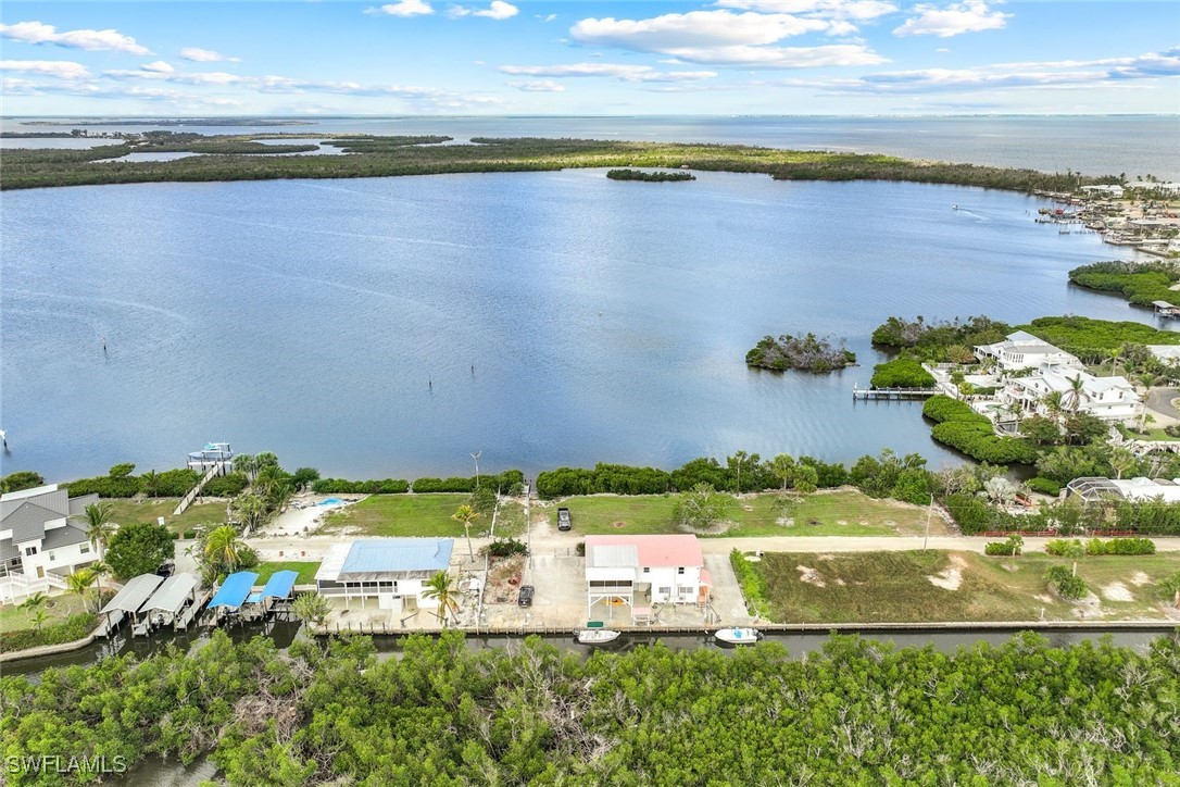 8151 Moyer Lane Bokeelia, FL 33922 - Photo 32 of 49 a view of a lake with a beach