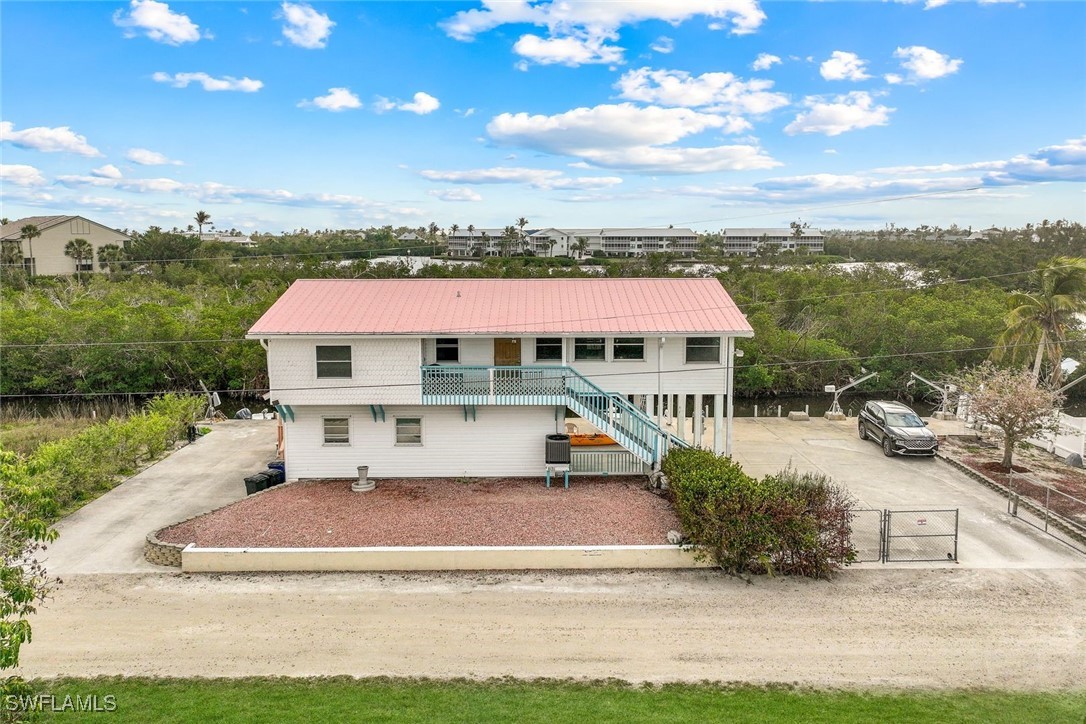 8151 Moyer Lane Bokeelia, FL 33922 - Photo 38 of 49 a view of a house with swimming pool and sitting area