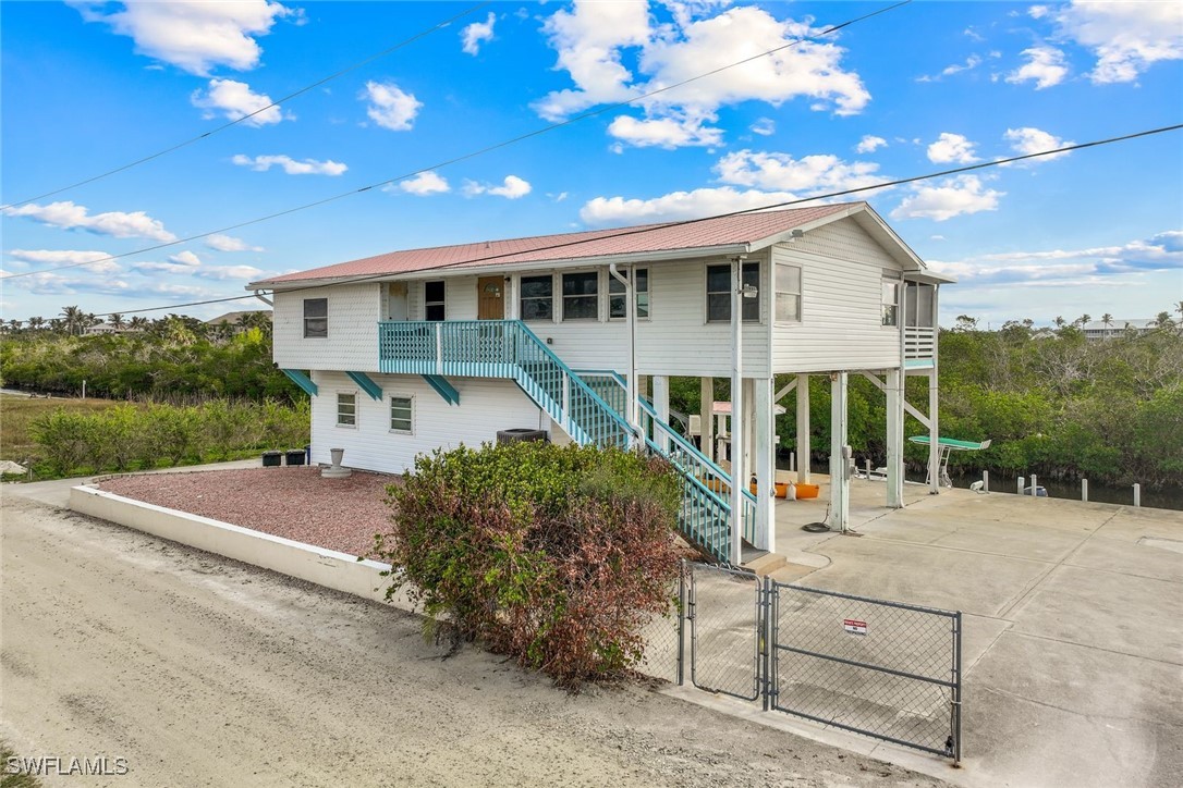 8151 Moyer Lane Bokeelia, FL 33922 - Photo 39 of 49 a view of a house with backyard and sitting area