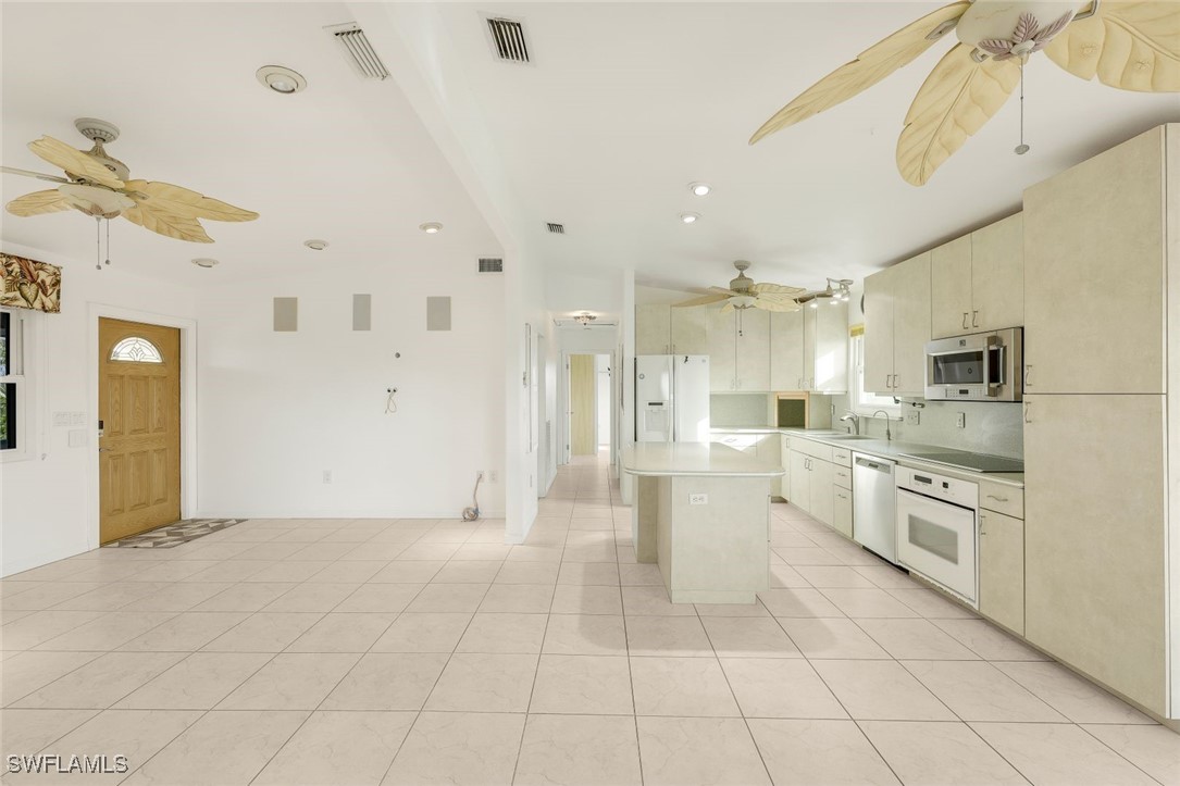 8151 Moyer Lane Bokeelia, FL 33922 - Photo 4 of 49 a large white kitchen with cabinets