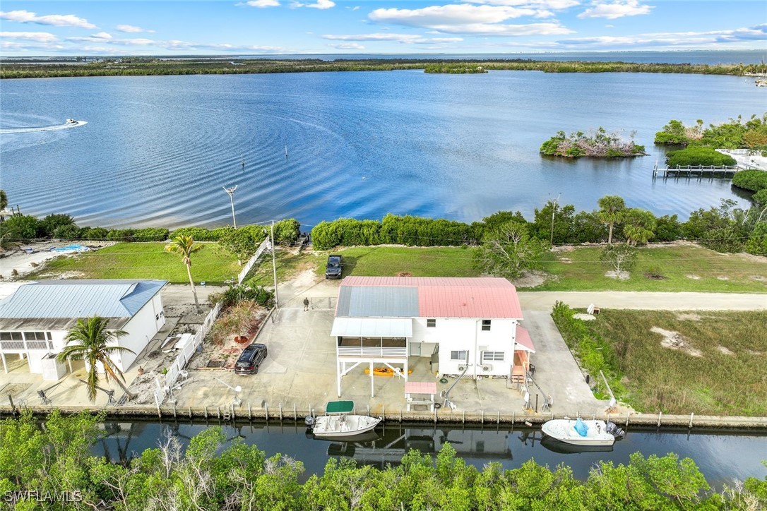 8151 Moyer Lane Bokeelia, FL 33922 - Photo 44 of 49 a view of swimming pool with seating area and yard with green floor