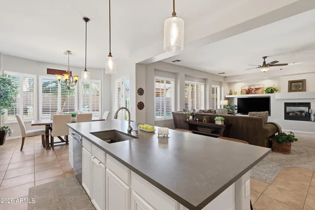 a living room with furniture a flat screen tv and a large window
