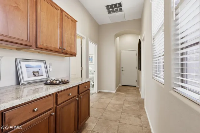 a kitchen with granite countertop a sink and cabinets
