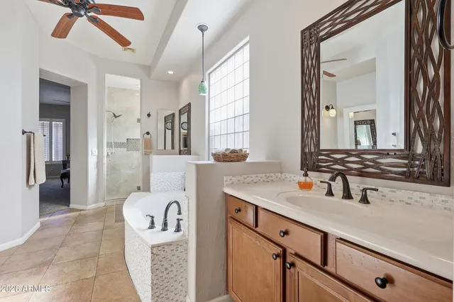 a spacious bathroom with a sink double vanity granite and a mirror