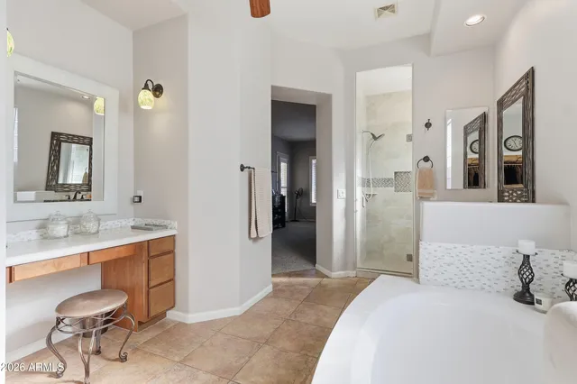 a en suite bathroom with a double vanity sink and a mirror