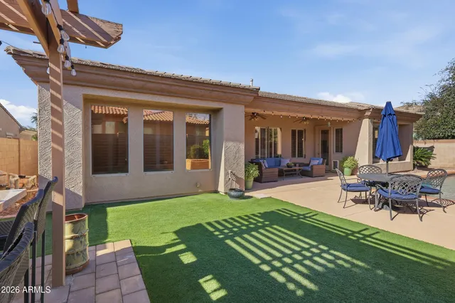 a view of a house with sitting area and a yard