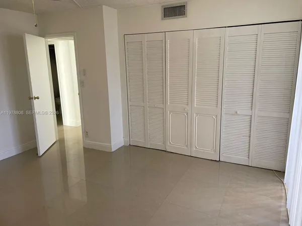 a view of an empty room with closet