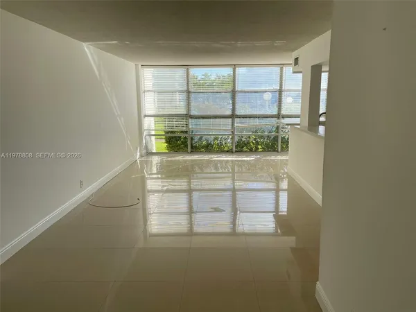 an empty room with a empty space and windows
