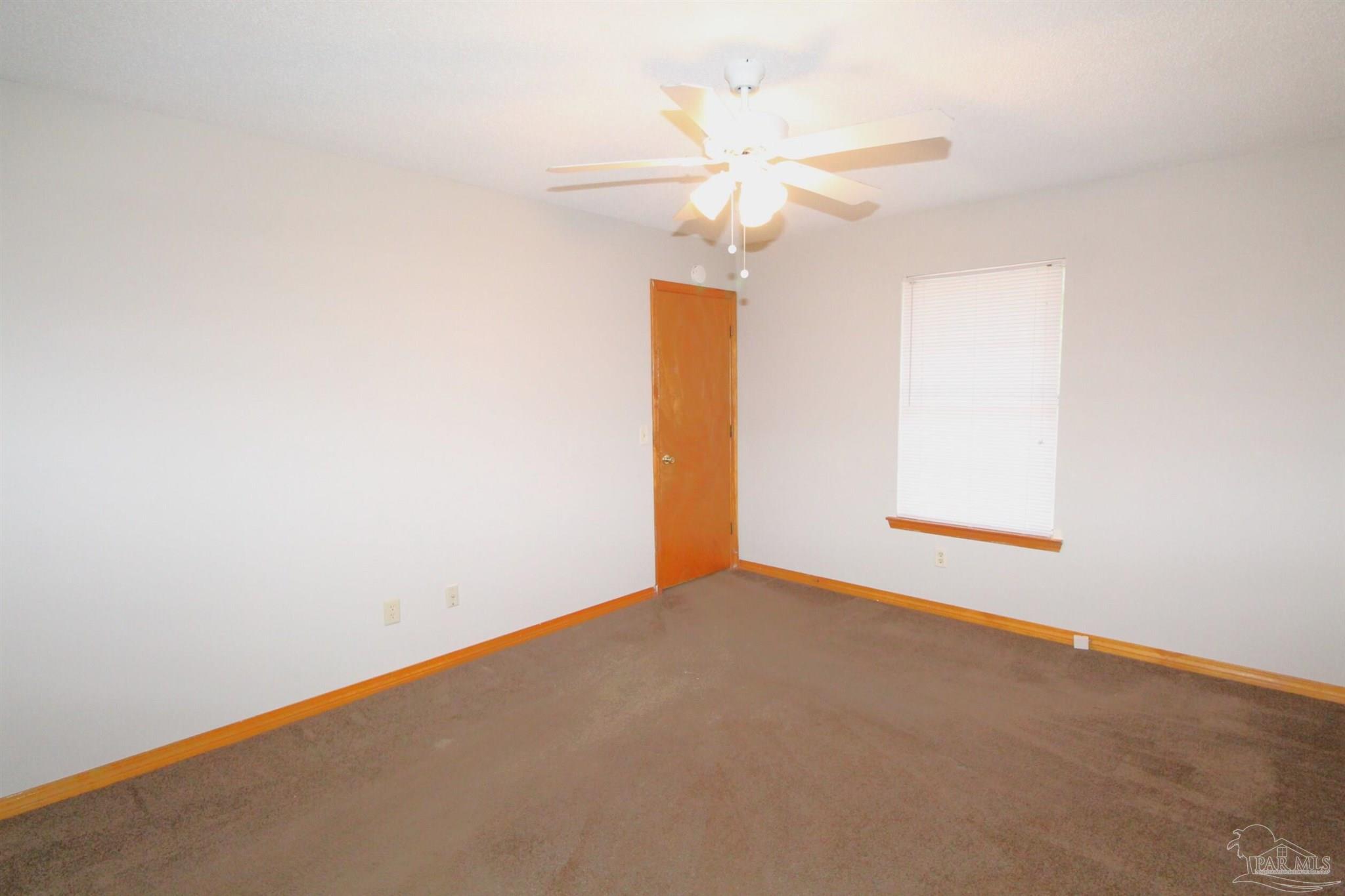 5306 Windham Road Milton, FL 32570 - Photo 11 of 15 an empty room with a window and a ceiling fan
