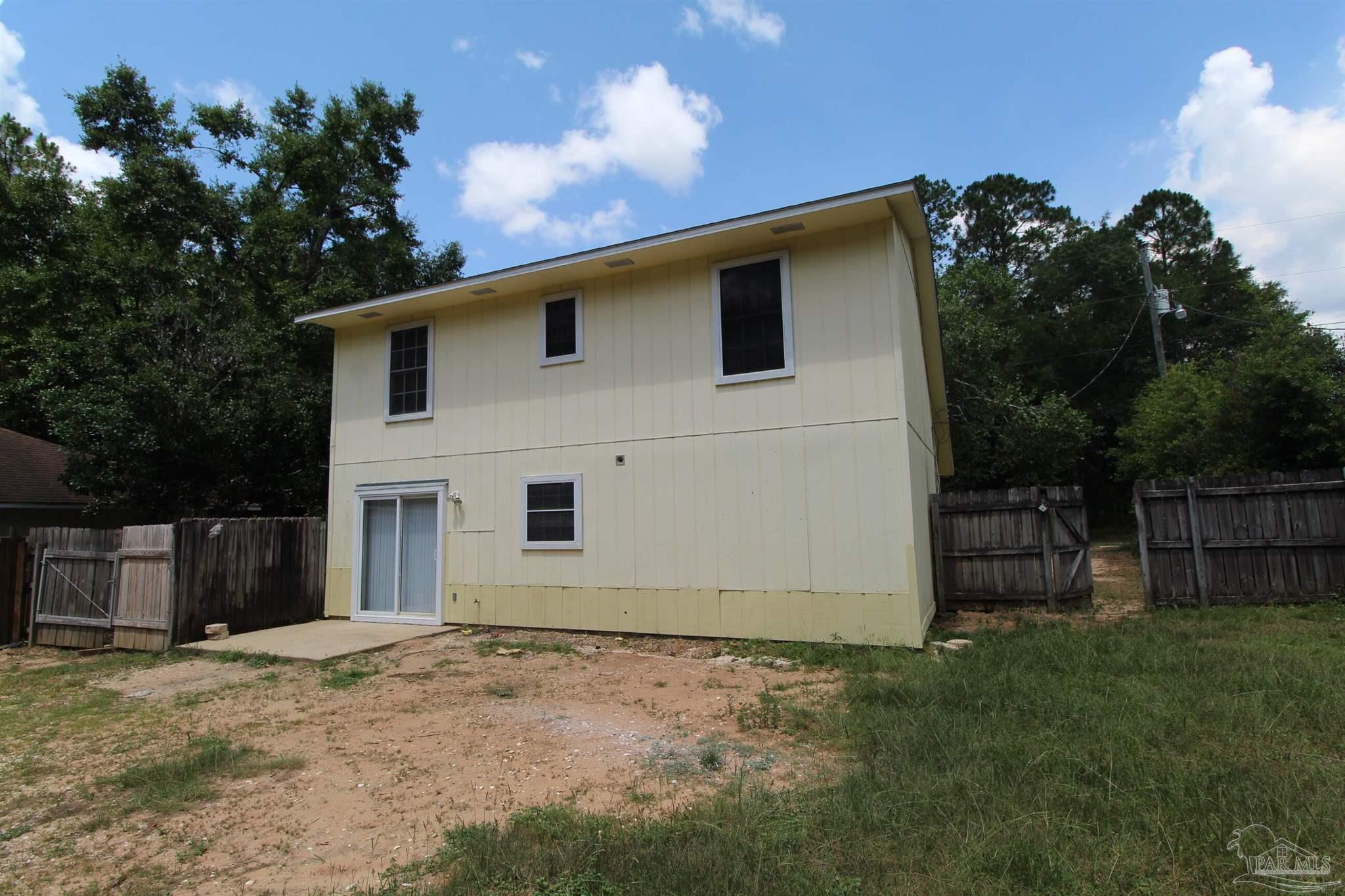 5306 Windham Road Milton, FL 32570 - Photo 14 of 15 a view of a house with a backyard