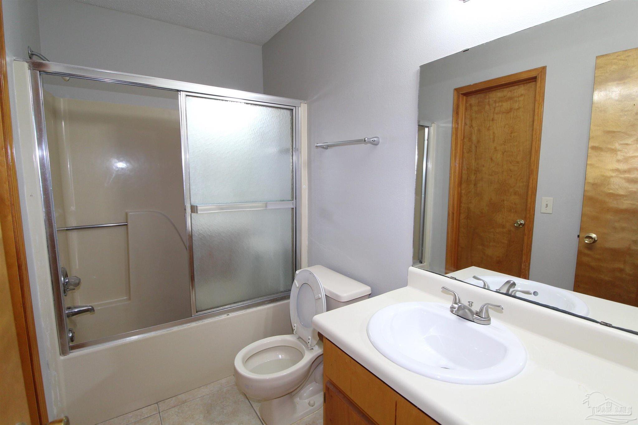 5306 Windham Road Milton, FL 32570 - Photo 7 of 15 a bathroom with a sink toilet and shower