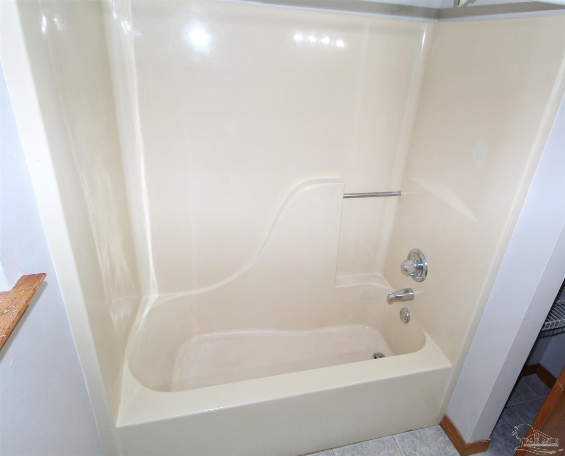 5306 Windham Road Milton, FL 32570 - Photo 10 of 15 a close up of a bathtub in a bathroom