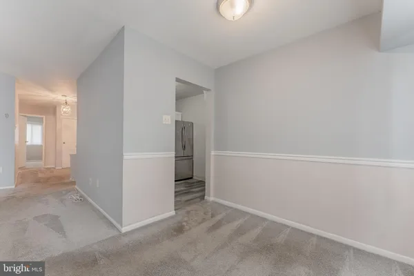 an empty room with a kitchen