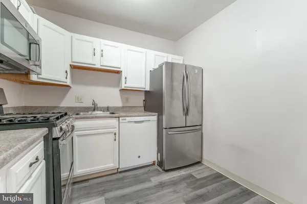 a kitchen with a refrigerator and a stove