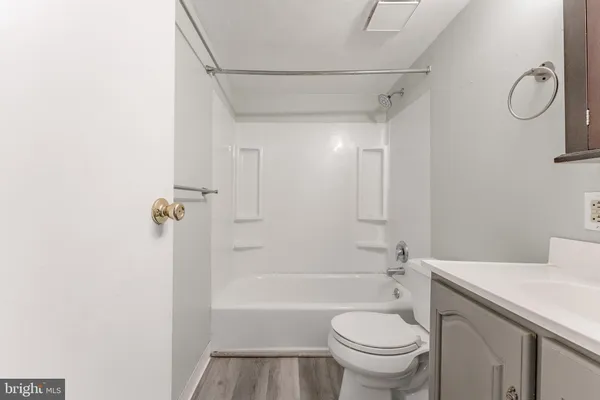 a bathroom with a toilet sink vanity and shower