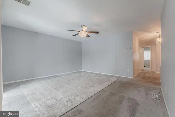 an empty room with fan and a ceiling fan