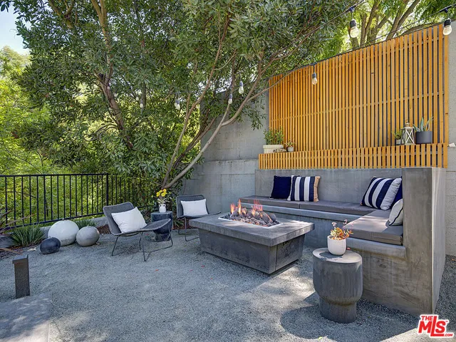 a roof deck with a table and chairs