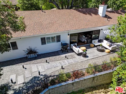 a view of house with outdoor space and sitting area