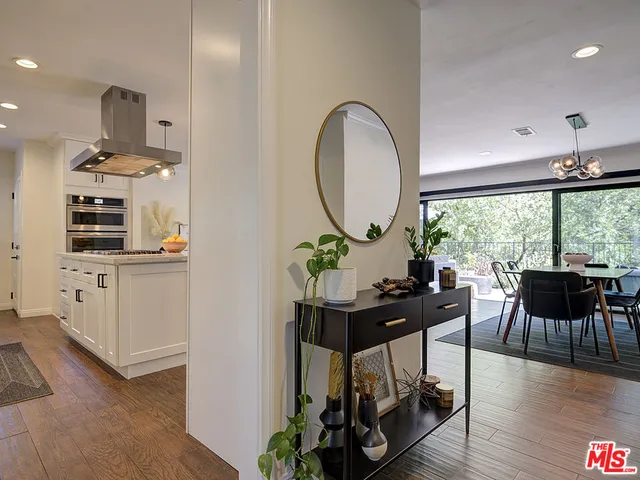 a view of a workspace with furniture window and wooden floor
