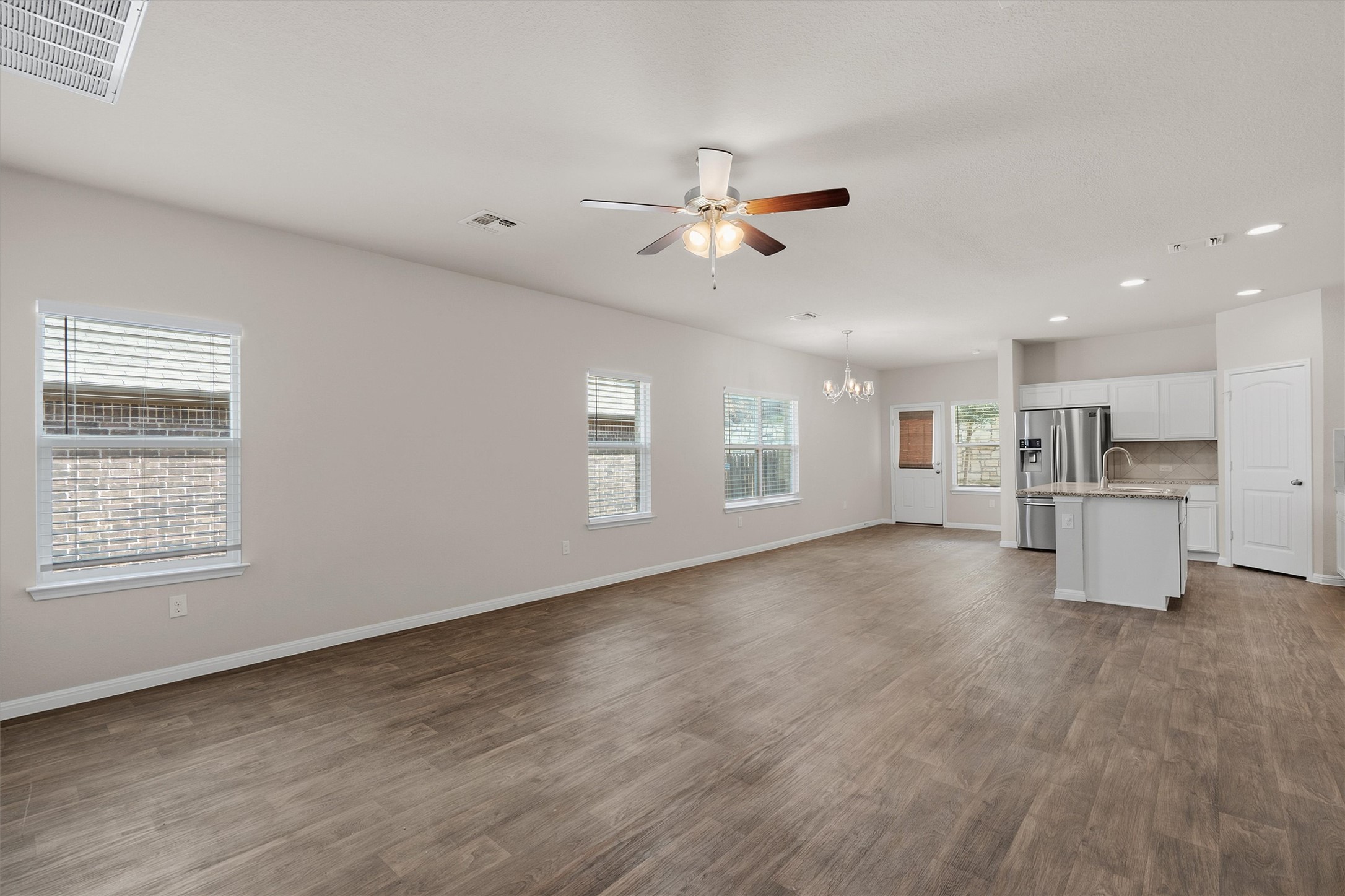The natural light pouring in from the large windows makes the whole living space feel bright and airy.