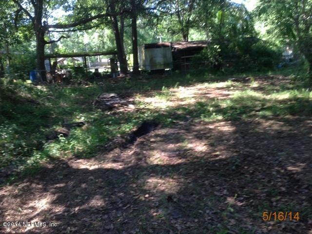 54694 Church Road Callahan, FL 32011 - Photo 20 of 22 a backyard of a house with lots of green space