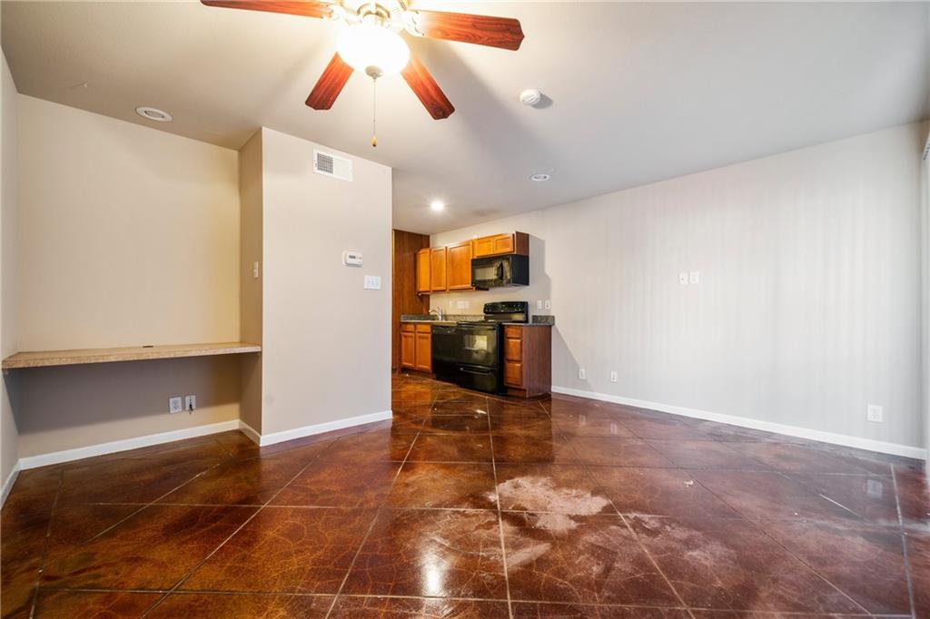 301 West 38th Street, Unit 109 Austin, TX 78705 - Photo 11 of 16 a view of a kitchen with a sink and a stove