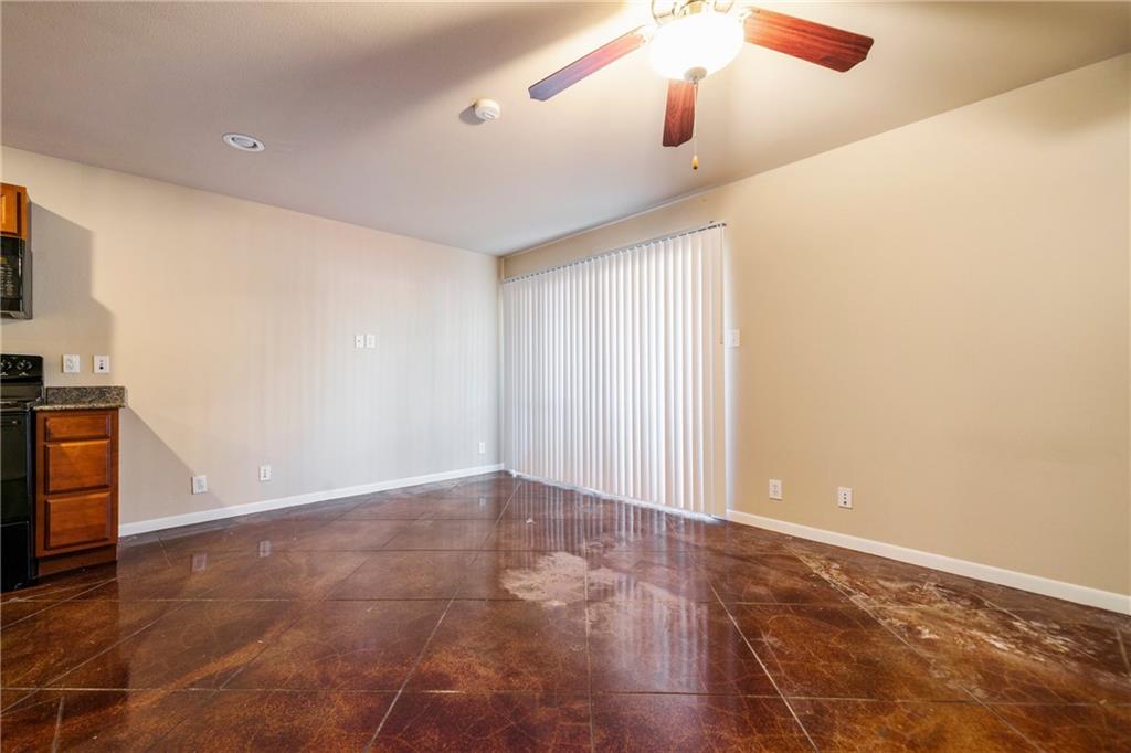 301 West 38th Street, Unit 109 Austin, TX 78705 - Photo 13 of 16 an empty room with wooden floor fan and windows