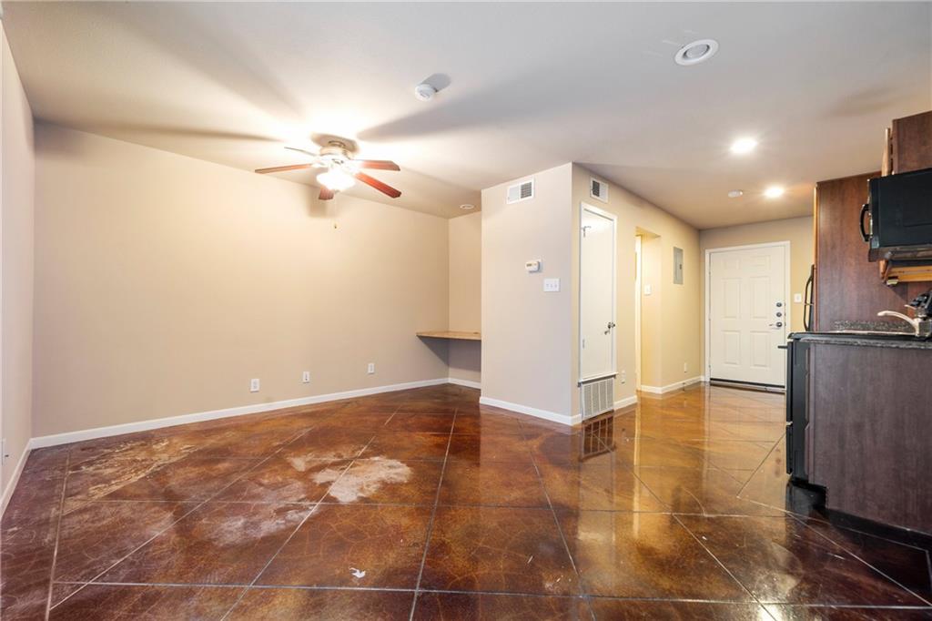 301 West 38th Street, Unit 109 Austin, TX 78705 - Photo 10 of 16 a view of a kitchen with a sink and a refrigerator