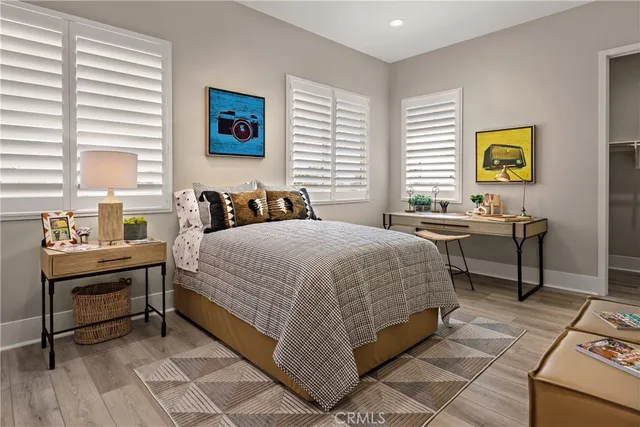 a bedroom with a bed and a desk