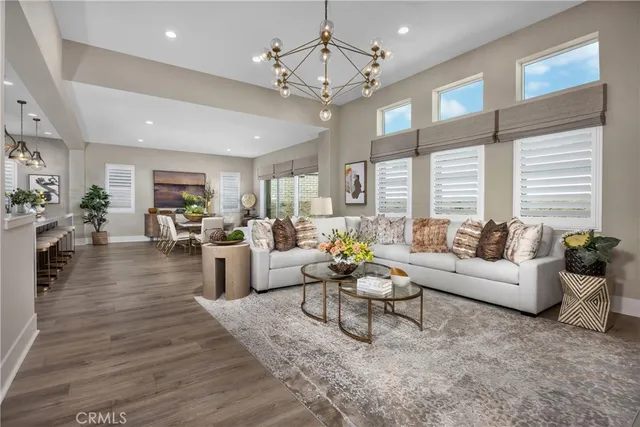 a living room with furniture or kitchen view and a wooden floor