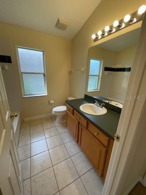 740 Pickfair Terrace Lake Mary, FL 32746 - Photo 20 of 26 a bathroom with a sink a mirror and a toilet
