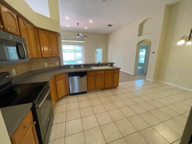 740 Pickfair Terrace Lake Mary, FL 32746 - Photo 9 of 26 a large kitchen with stainless steel appliances granite countertop a sink and cabinets