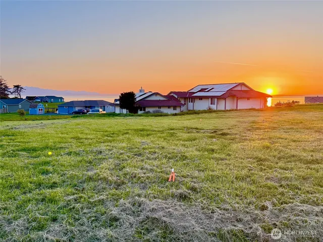 a view of a lake with a house in the background