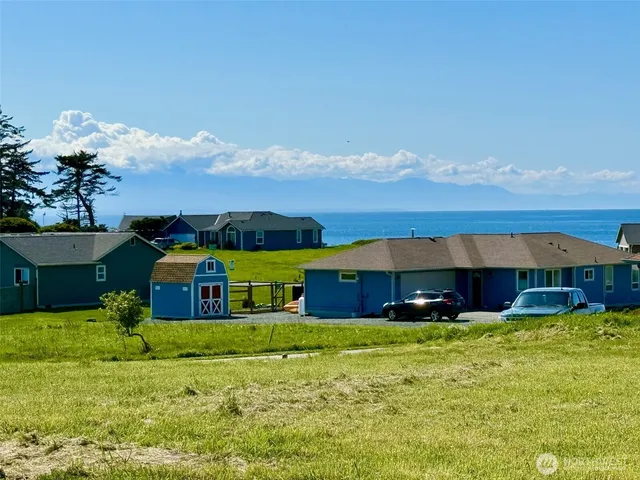 a front view of house with yard and car parked